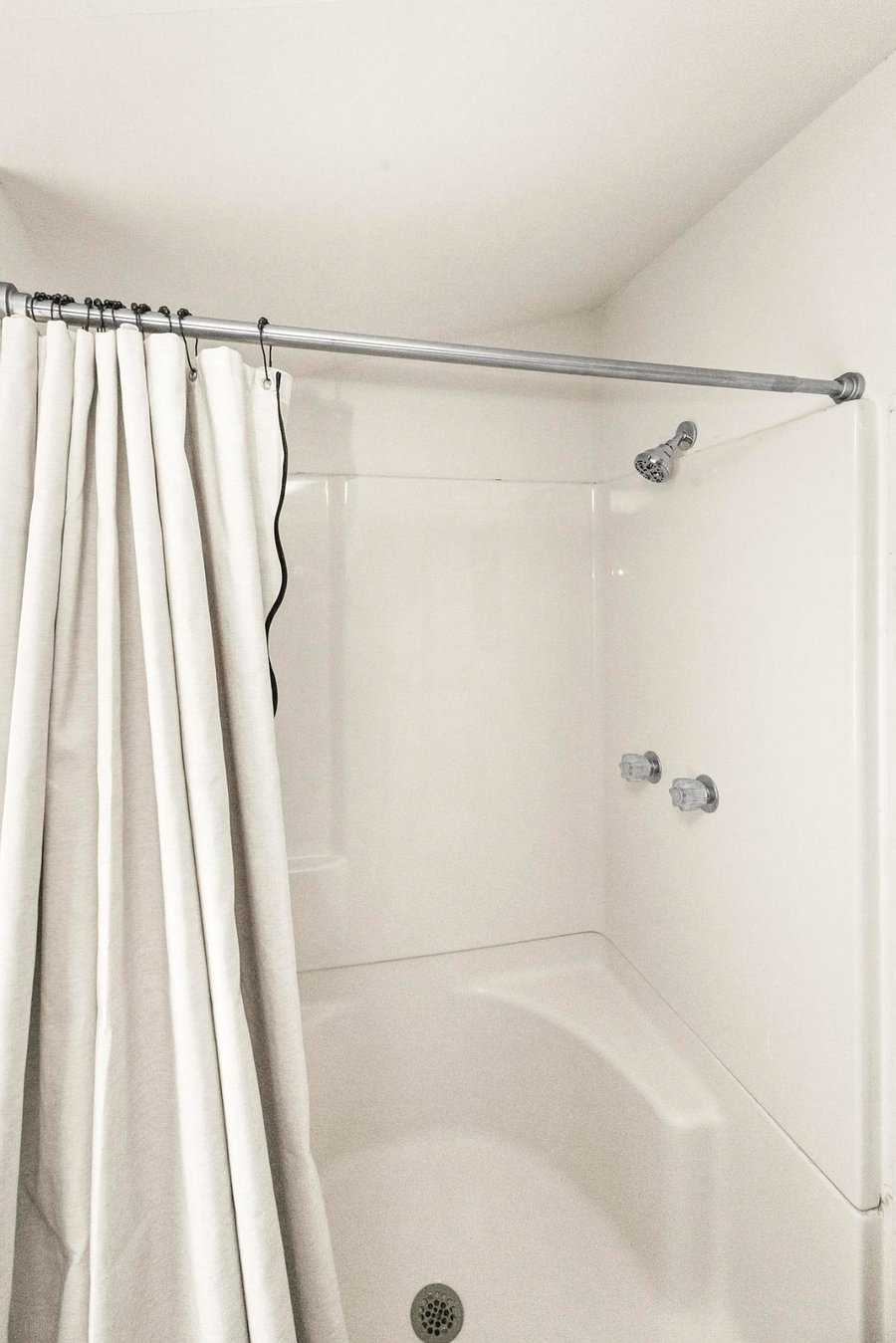 Refresh in a full walk-in shower, complete with a curtain for privacy and a simple, easy-to-use setup!