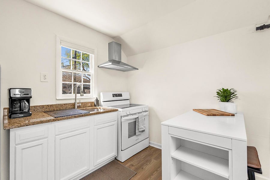 Cook with natural light and a full-size electric oven, complete with an exhaust hood for easy ventilation.
