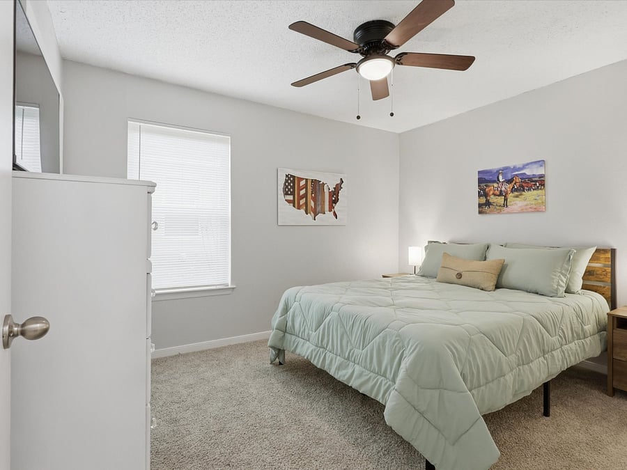 Bedroom 2 with queen size bed directly across hall from full guest bath.