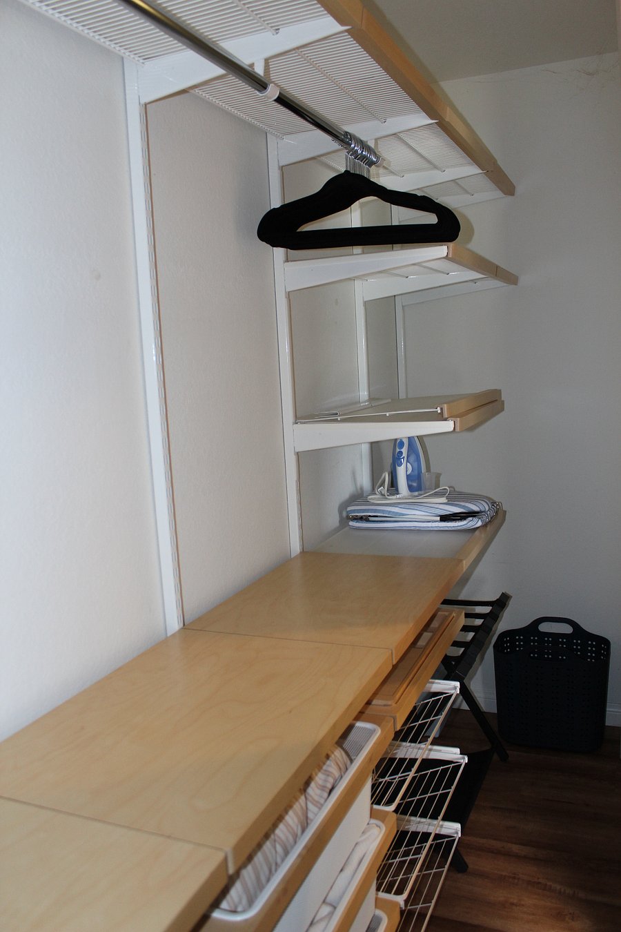 Large closet with built-in drawers and lots of space for storage.