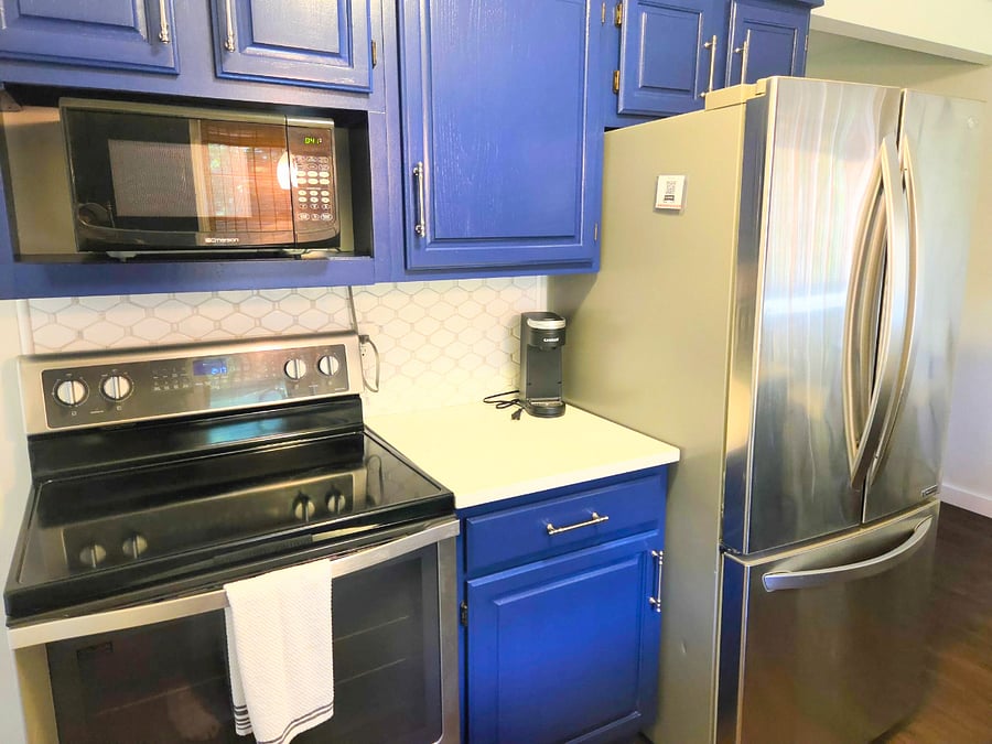 Galley kitchen complete with full sized refrigerator, oven and range, microwave k-cup style coffee machine, dishwasher, and garbage disposal. Includes lots of kitchen basics such as dinnerware, cutlery, pots, skillets, strainers, cutting boards, glass and stemware.