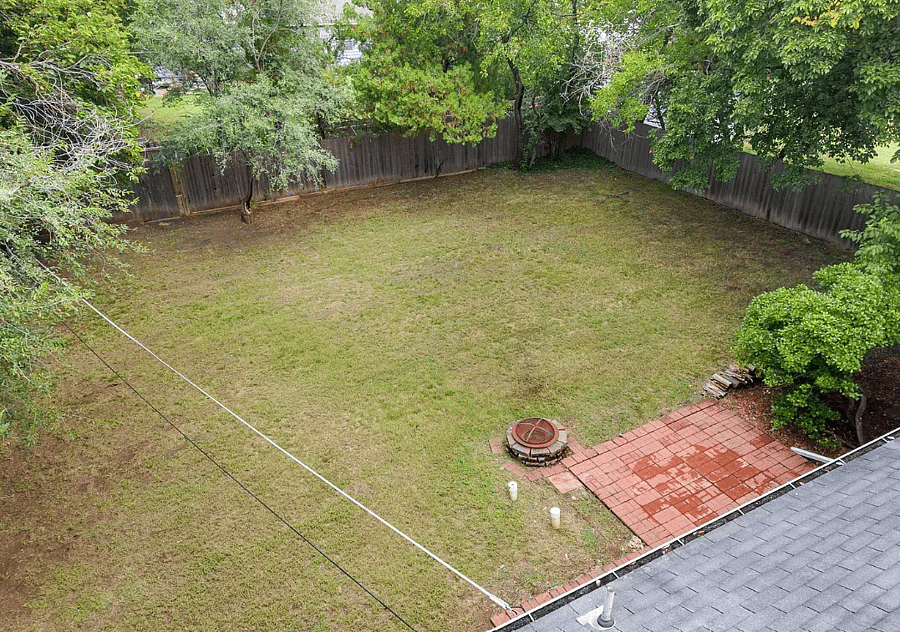 Fenced backyard with firepit and patio