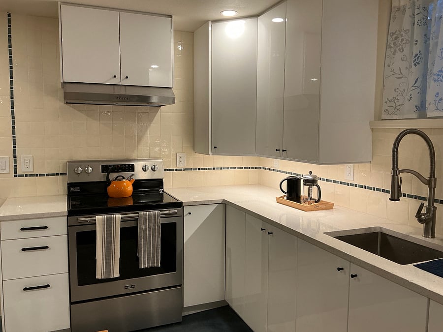 full-size appliances and well-lit quartz countertops