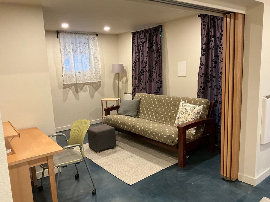 front room faces garden, can be used as BR or LR, has nook with desk and designer office chair