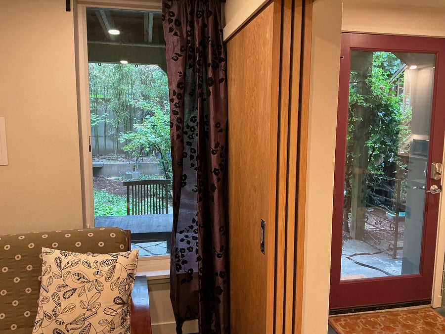 wood panels slide out to create optional wall between front room and kitchen