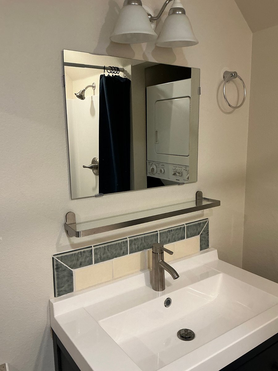 vanity with tile backsplash