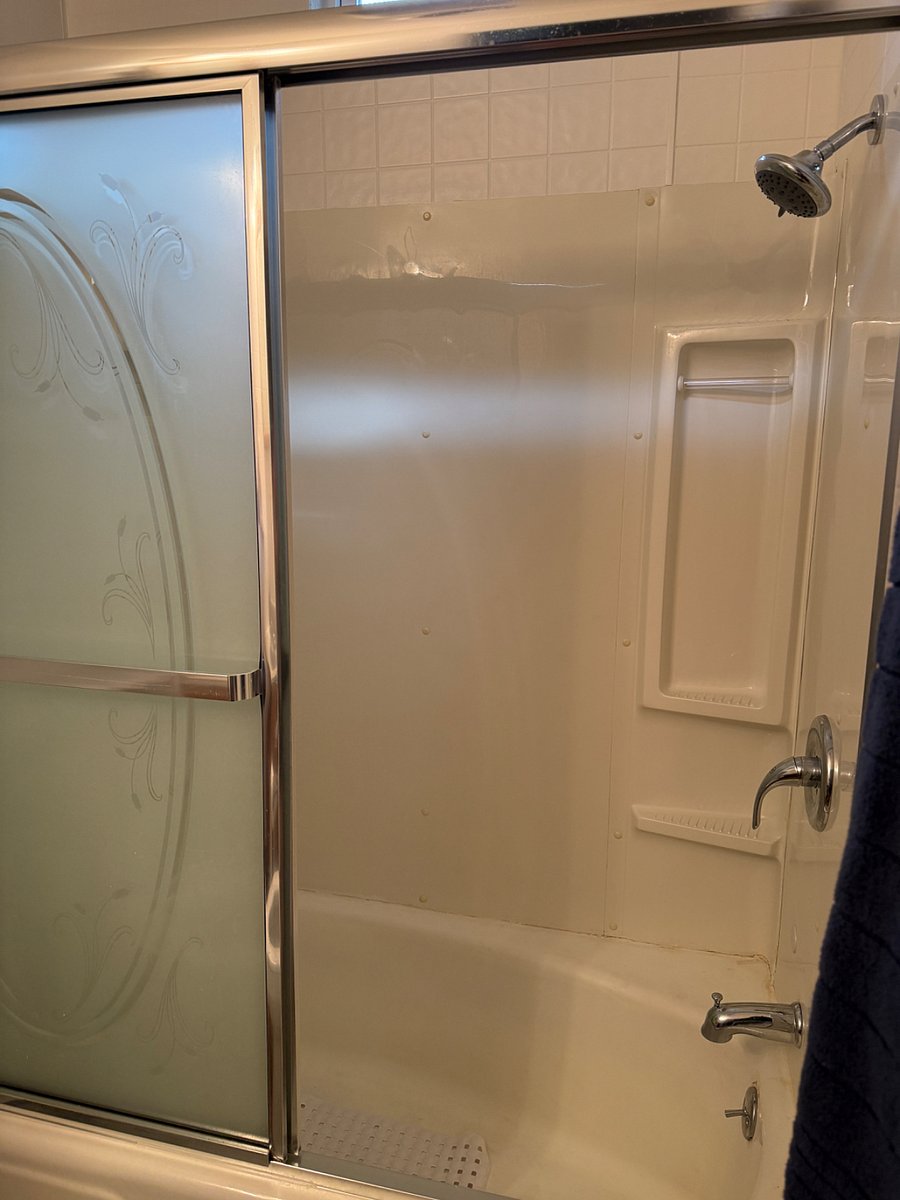 Shower has a sliding door. 