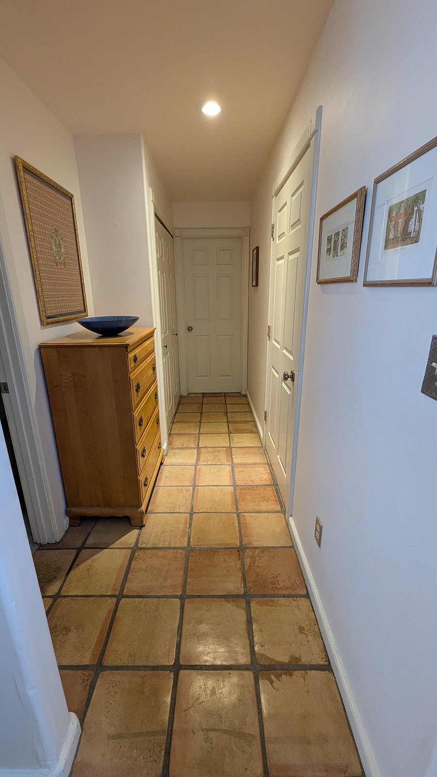 Downstairs hallway leading to bedroom, laundry closet with full size washer and dryer, and bathroom