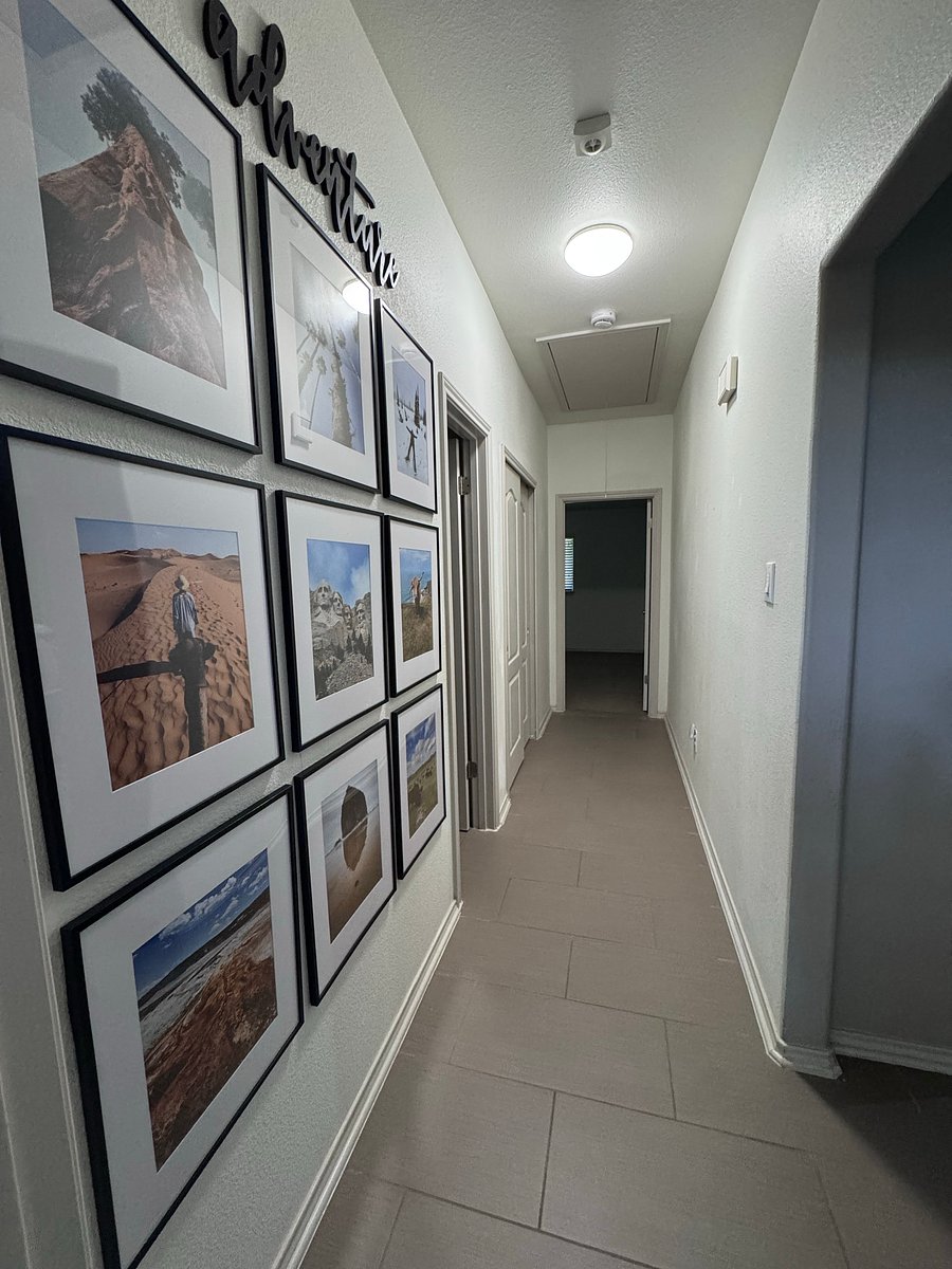 Hallway from living room connecting second (behind) and third bedrooms (straight), with guest bath in between (left)