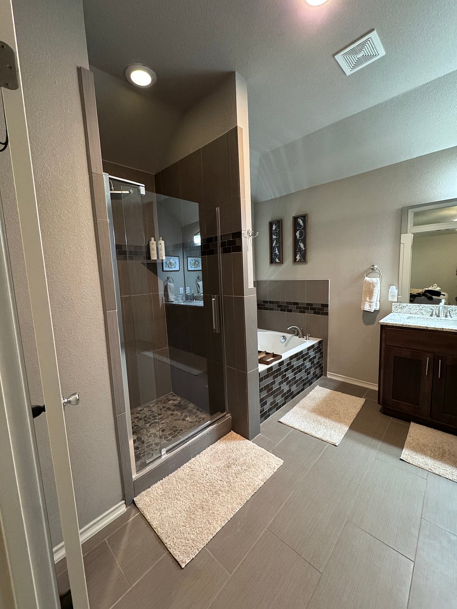 Master bathroom includes: double vanity, large soaker bathtub, shower, toilet, and large walk-in closet
