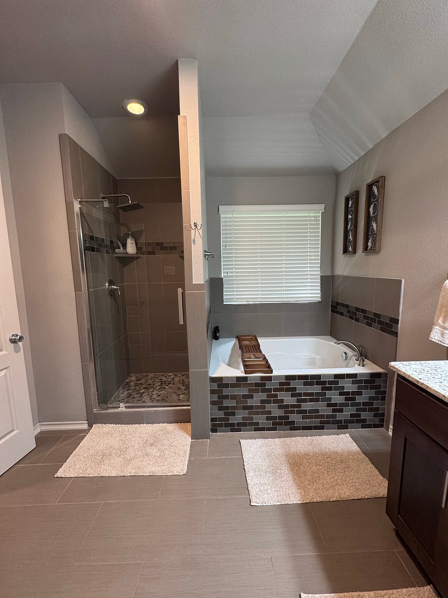 Master bathroom includes: double vanity, large soaker bathtub, shower, toilet, and large walk-in closet