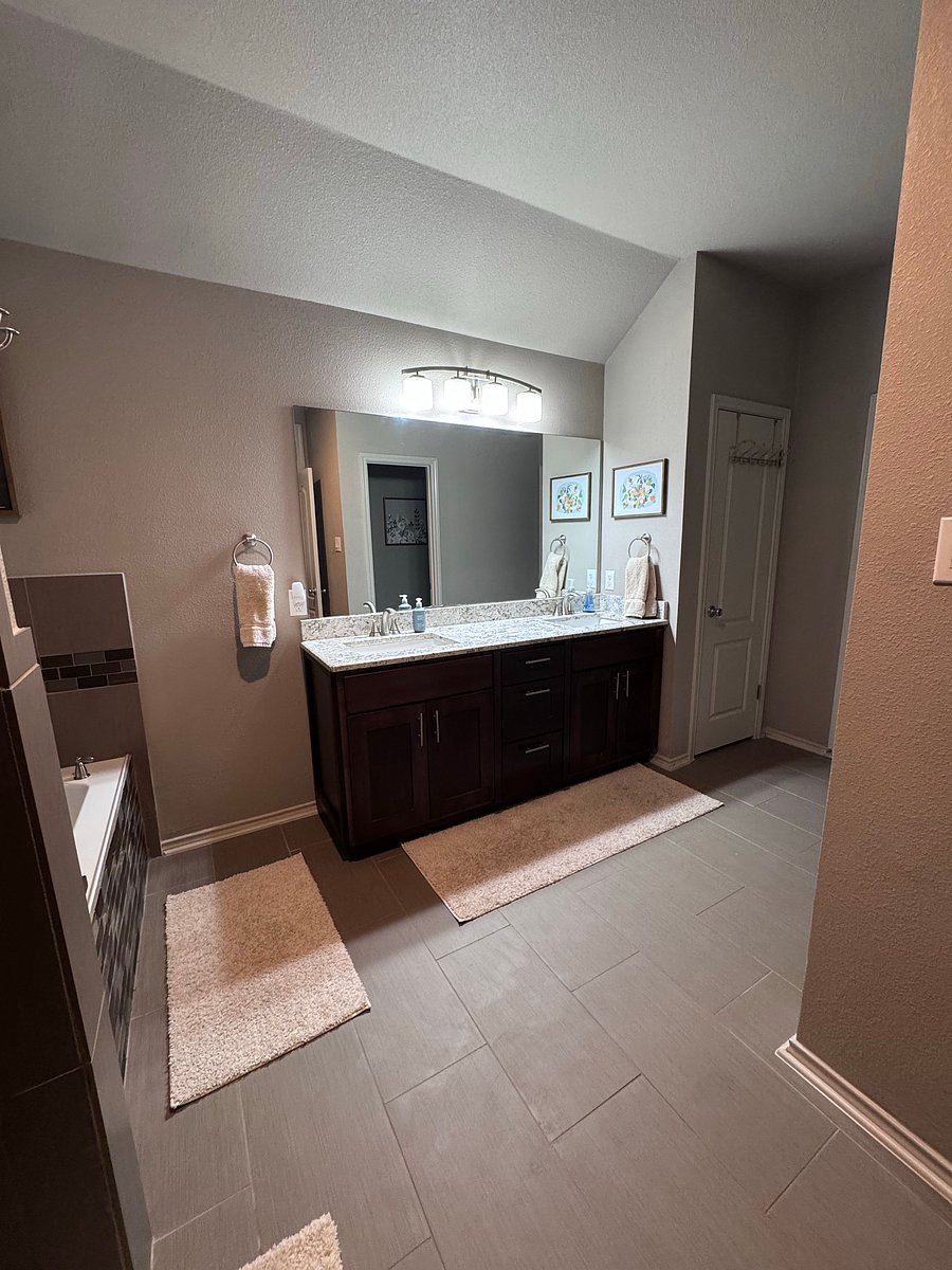 Master bathroom includes: double vanity, large soaker bathtub, shower, toilet, and large walk-in closet