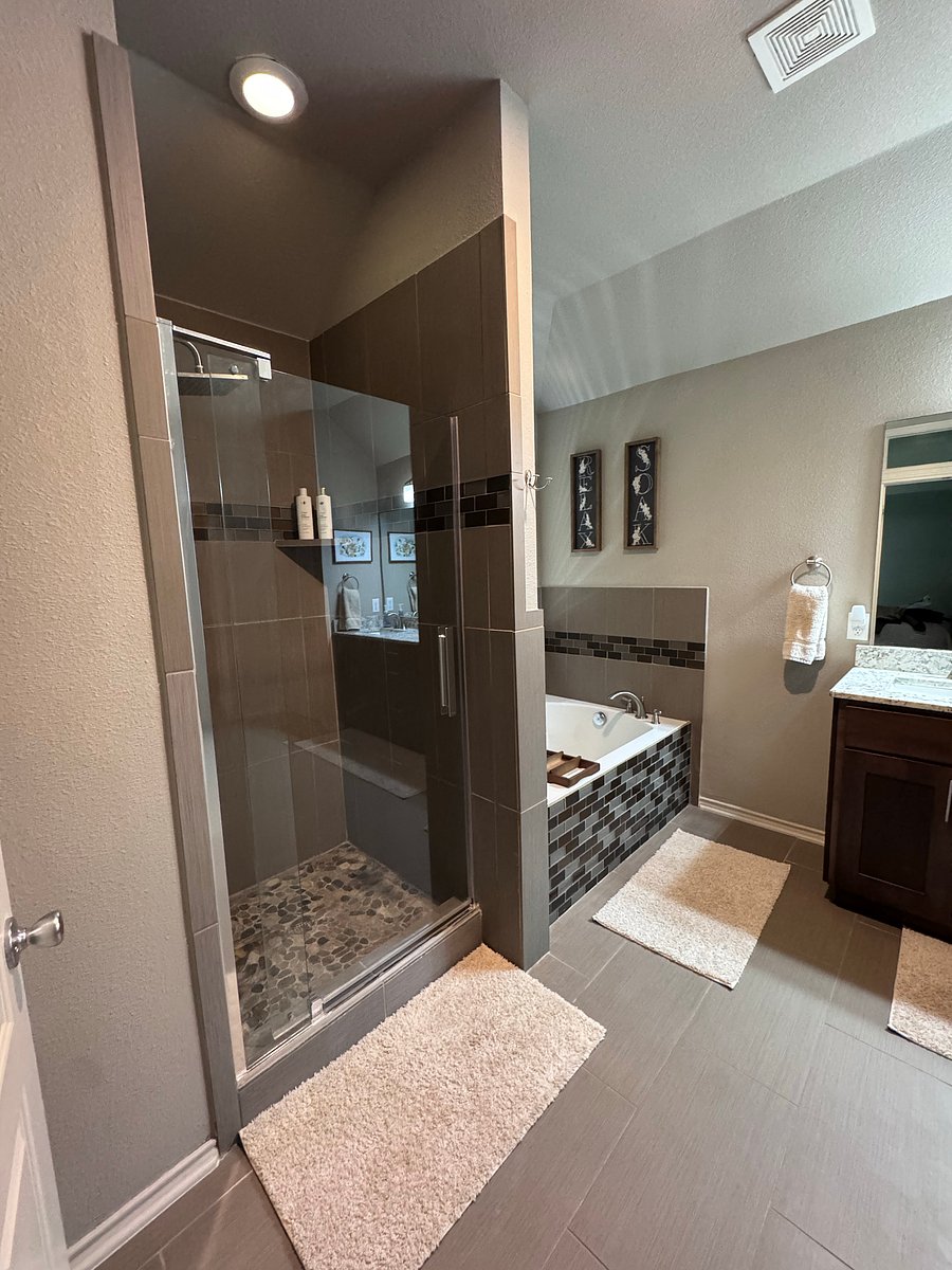 Master bathroom includes: double vanity, large soaker bathtub, shower, toilet, and large walk-in closet