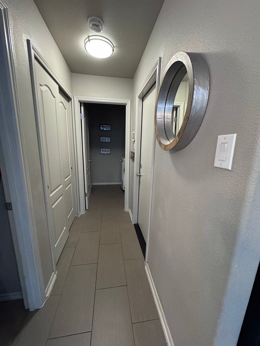 Hallway from kitchen leading to master bedroom (left), garage (right), and laundry room (straight)