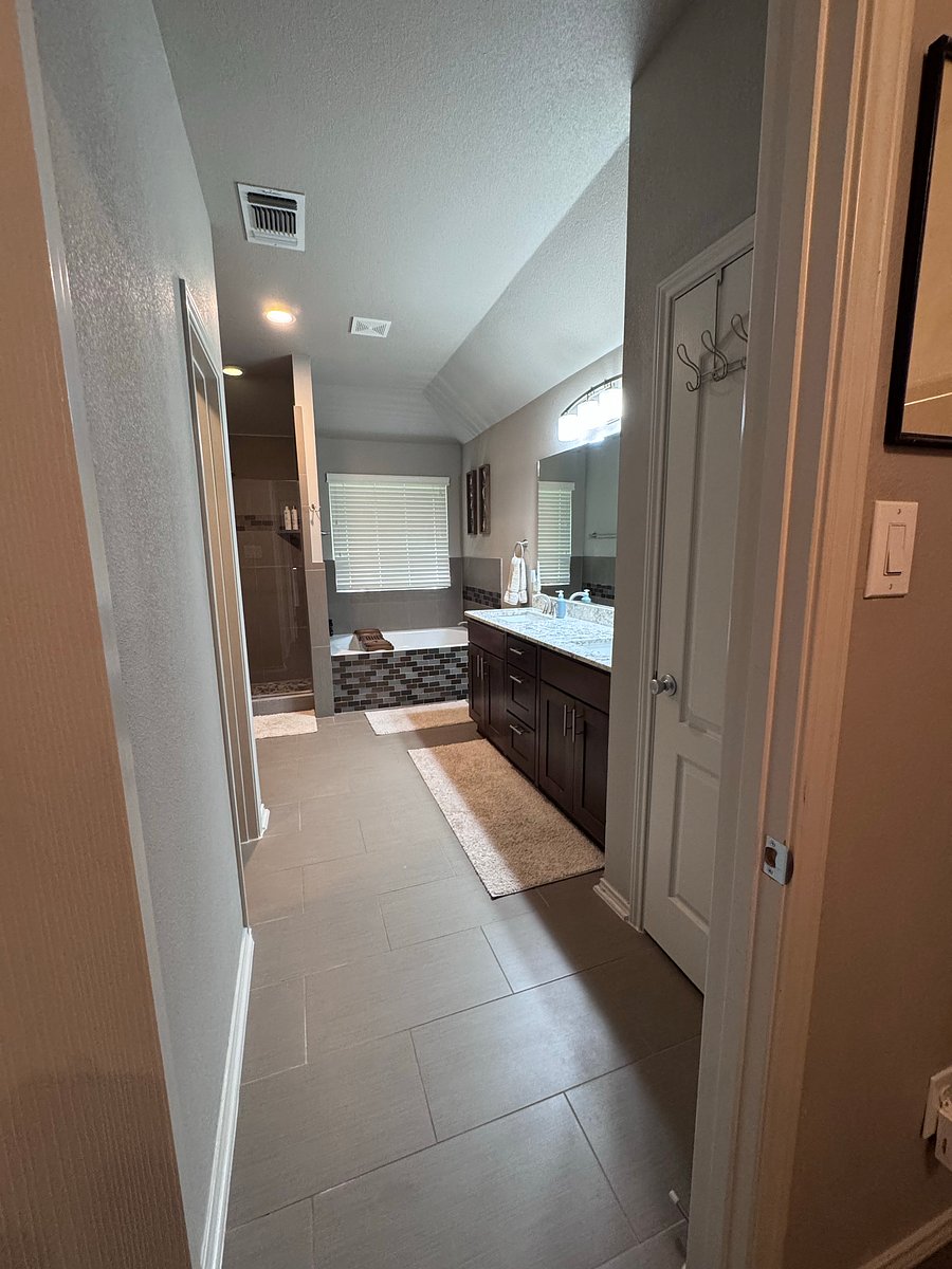 Master bathroom includes: double vanity, large soaker bathtub, shower, toilet, and large walk-in closet