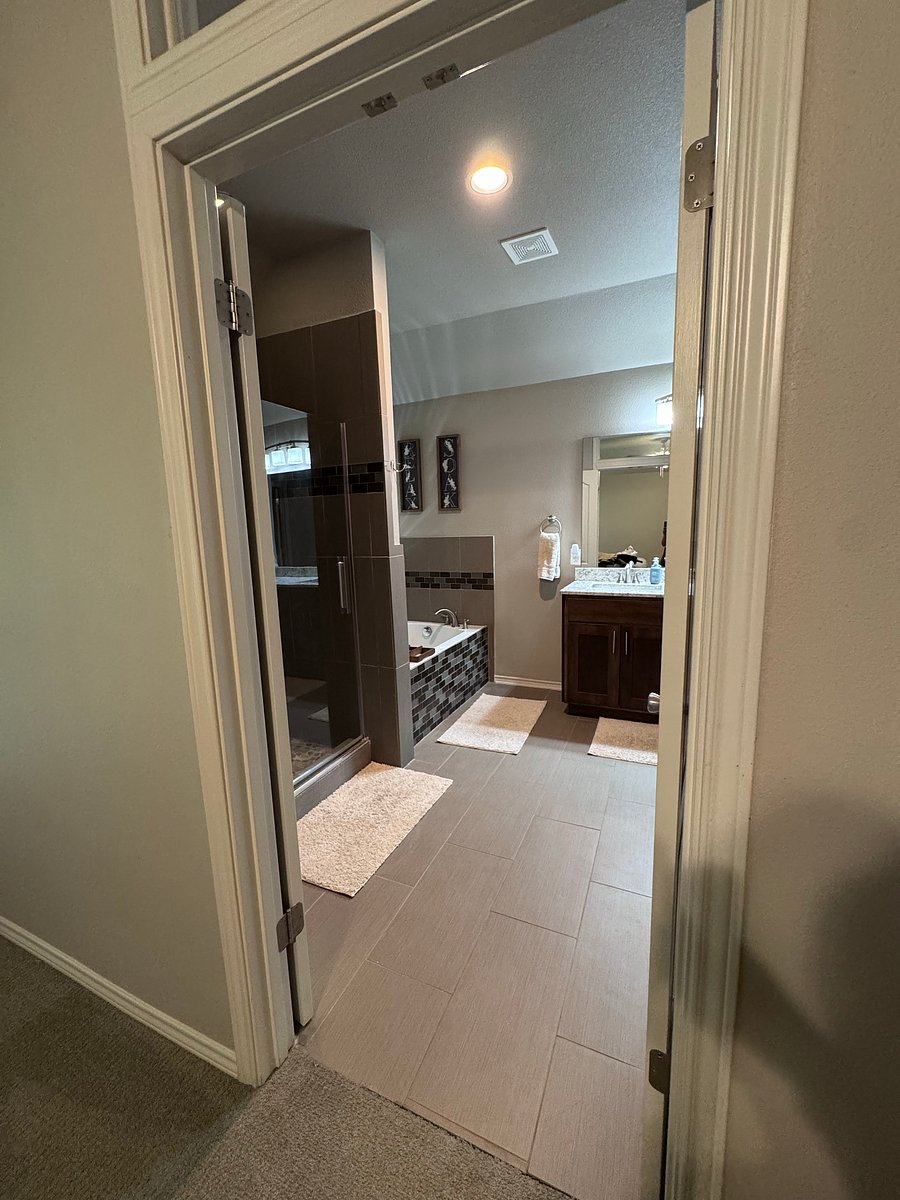 Master bathroom includes: double vanity, large soaker bathtub, shower, toilet, and large walk-in closet