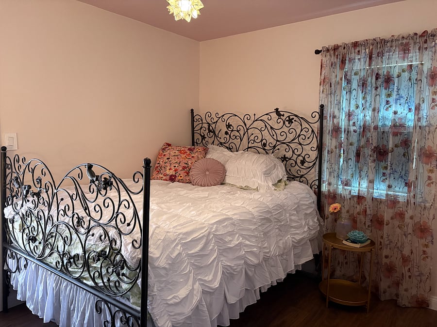 Primary bedroom- queen size bed, dresser, closet, french doors to backyard