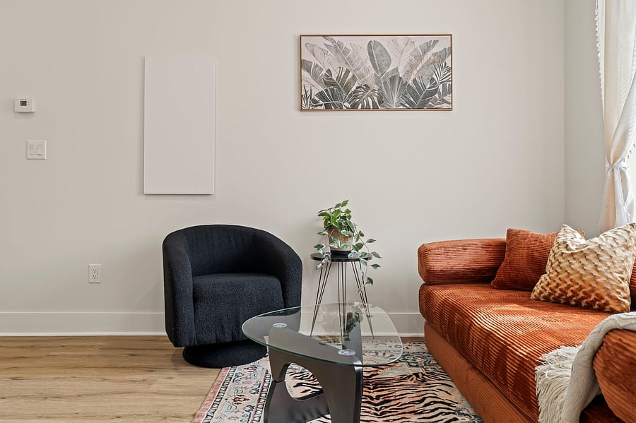 Curl up in the sculptural accent chair with a book or coffee. Thoughtful decor and natural textures make this space feel calm and lived-in.