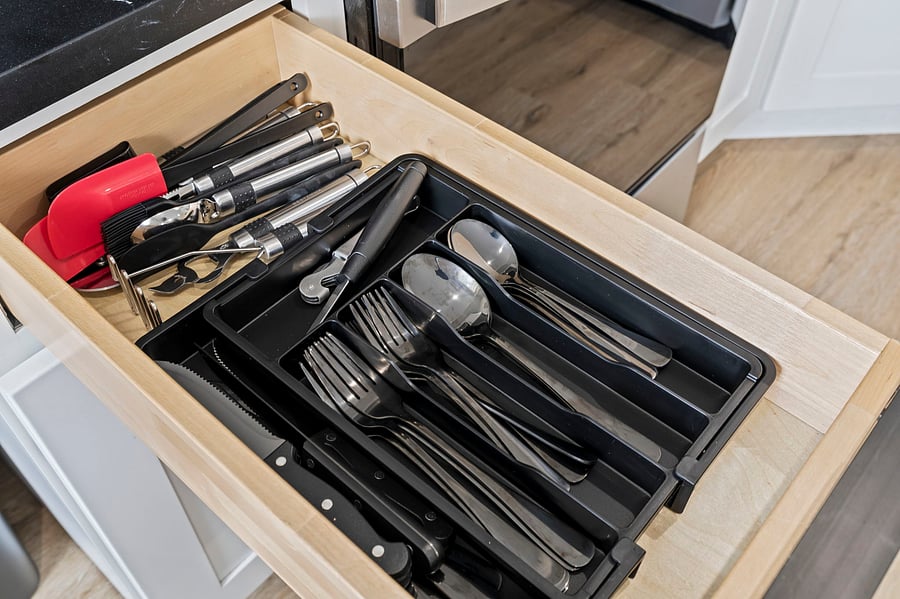 Fully stocked and neatly organized. Silverware and serving utensils are ready so you can unpack groceries, not kitchen supplies.