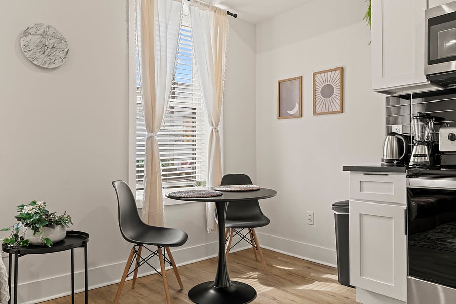Enjoy morning coffee or a home-cooked dinner at your sunny bistro table for two, steps from a full kitchen stocked with everything you need for a longer stay.