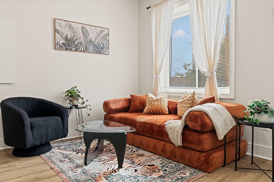Bright, airy and full of character, this living room is where long days end comfortably, whether you are coming off a shift or wrapping up research.