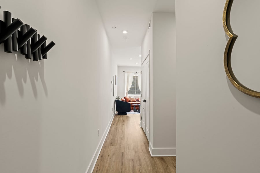 Hang your keys and coat as you walk in, then follow the light down the hall into a warm, boho living space made for unwinding after a long shift or class.