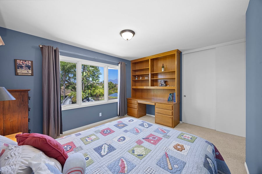 Bright guest suite featuring a Queen bed, private en suite bathroom, and built-in workspace for remote work or study.
