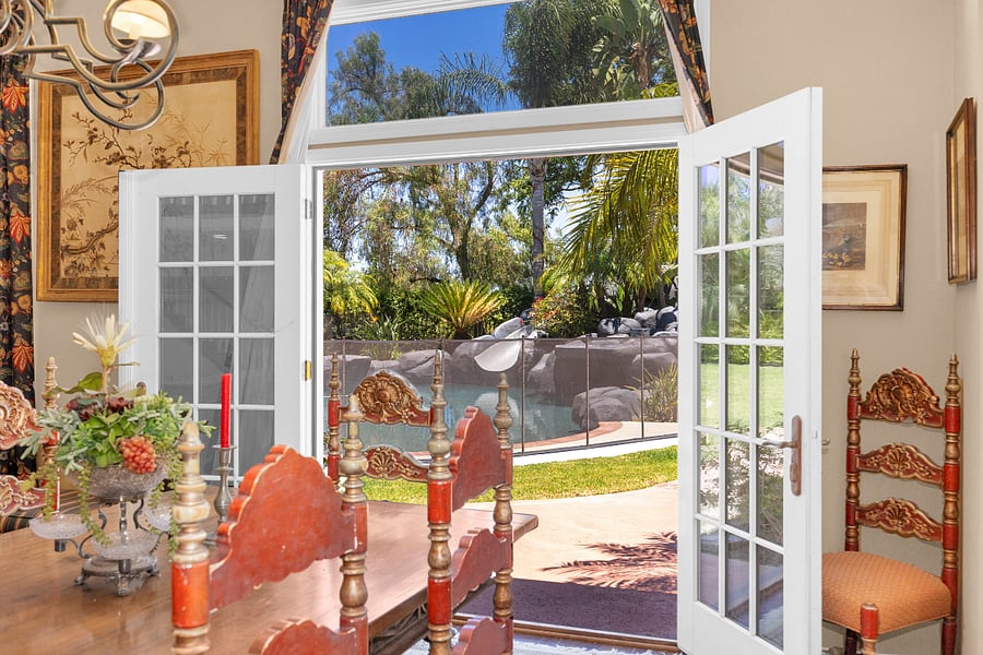 French doors open directly from the dining room to the resort-style backyard and pool, creating an ideal indoor-outdoor setting