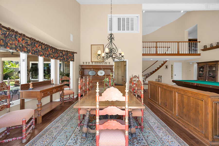 Spacious formal dining area with soaring ceilings and an open layout, providing plenty of room for comfortable everyday living during longer stays.