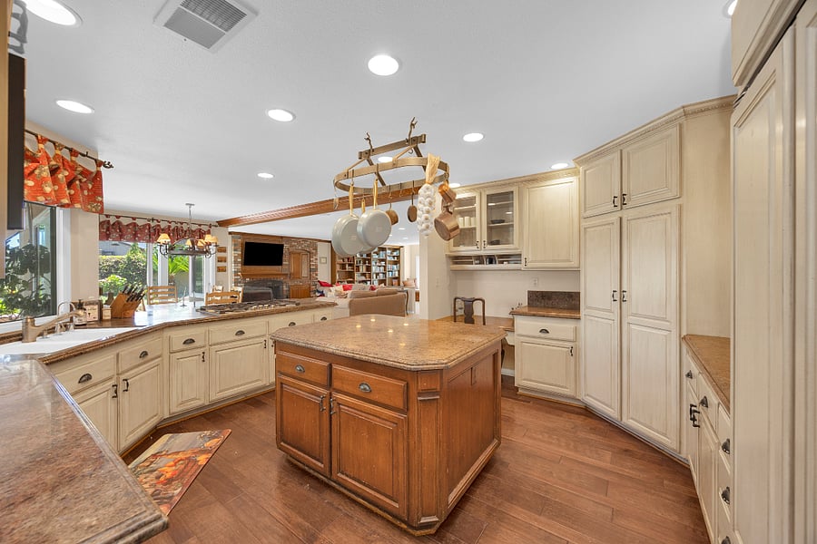 Fully equipped kitchen with a large center island, generous counter space, and ample storage, ideal for comfortable everyday living during extended stays.