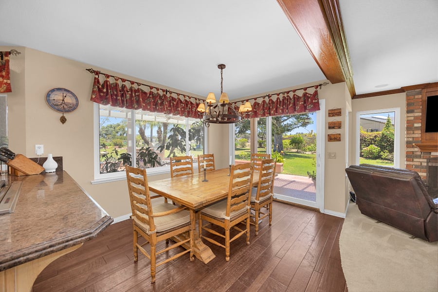 Bright casual dining area just off the kitchen, with beautiful backyard views and direct access to the outdoor living space.
