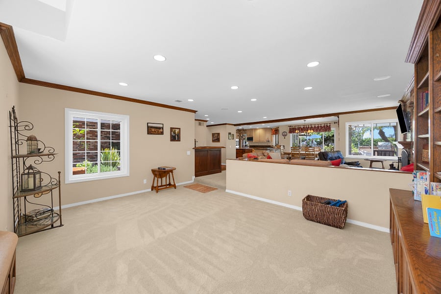 Spacious additional living area with built-in bookshelves, offering a comfortable spot for reading, relaxing, or enjoying some quiet time.