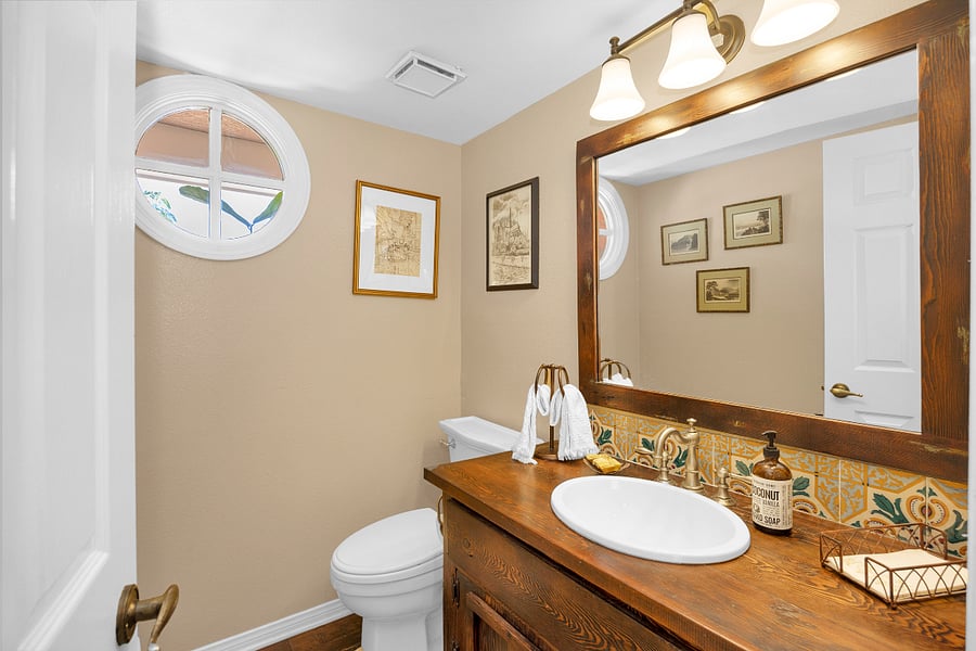 Convenient main-level half bathroom, thoughtfully appointed and easily accessible from the homes primary living areas.