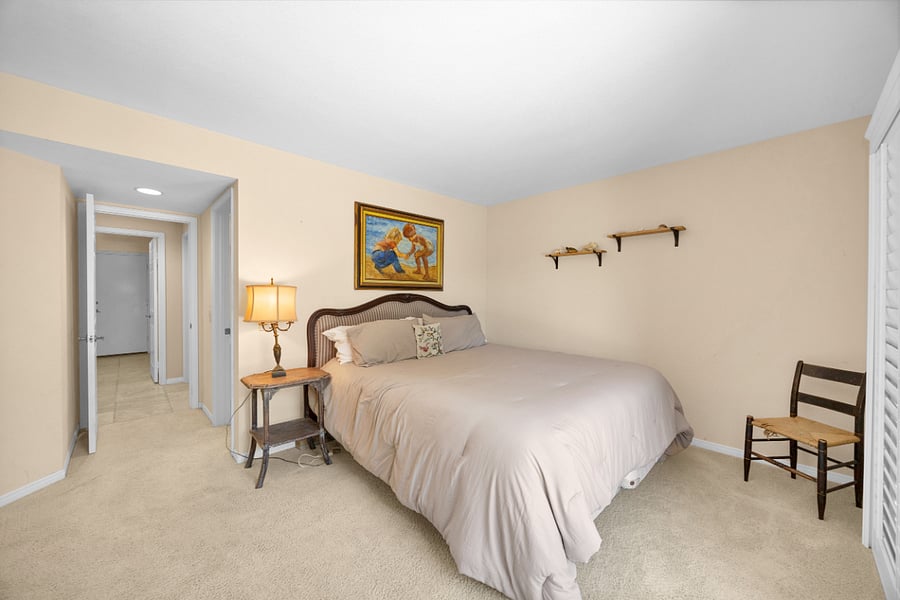 Comfortable lower-level bedroom with a king bed and convenient direct access to the backyard.