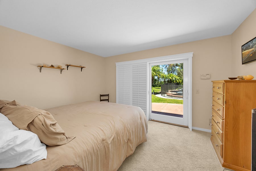Spacious lower-level king bedroom with comfortable furnishings and easy access to the backyard and outdoor living areas.