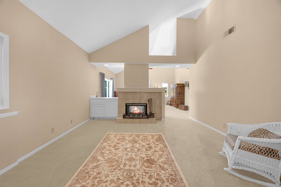 Private sitting area off the primary suite with a cozy fireplace, offering additional space to relax and unwind.