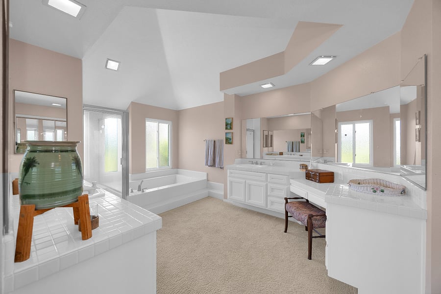 Spa-like primary bathroom with an open, airy layout, oversized soaking tub, separate shower, and expansive vanity area.
