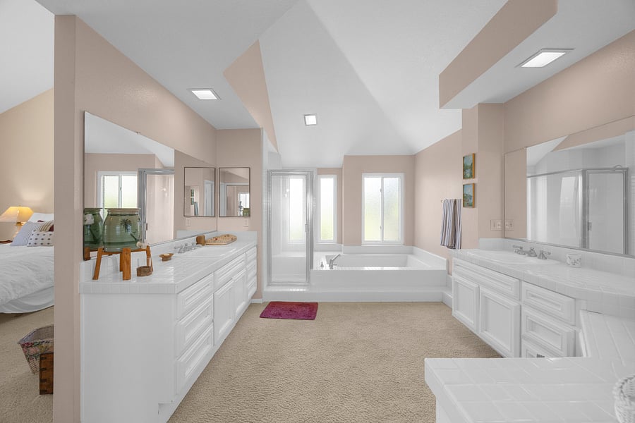 Unwind in the spacious, spa-like primary bathroom with dual vanities, a deep soaking tub, separate shower, and plenty of room to relax and recharge.