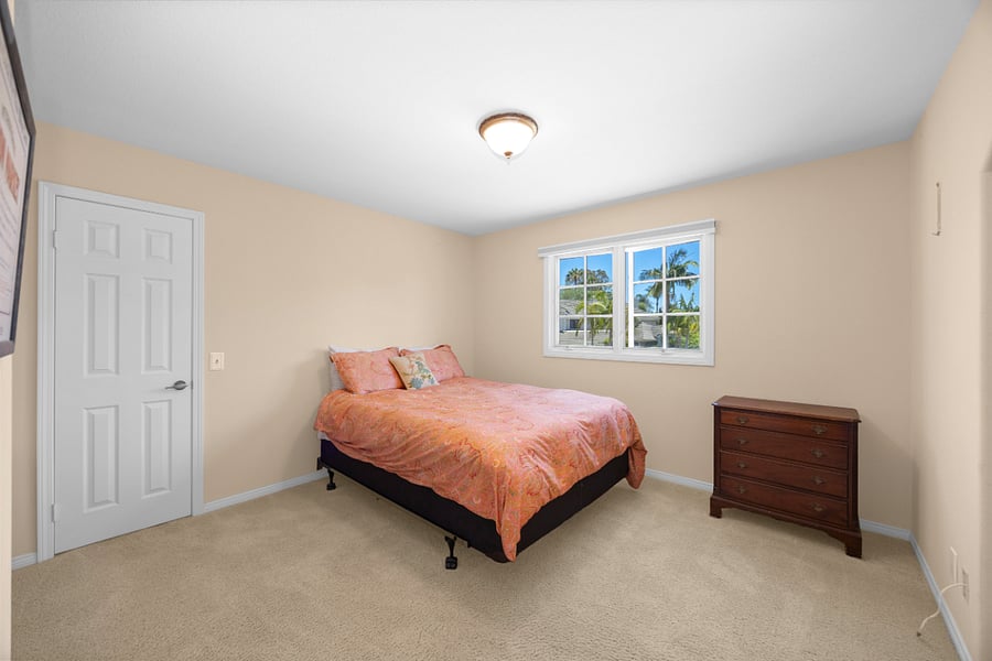 Bright and comfortable queen bedroom with ample storage and peaceful views of the surrounding Nellie Gail neighborhood.
