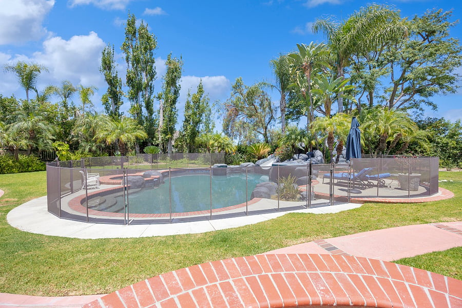 Enjoy the private resort-style pool and spa, surrounded by lush landscaping and protected by a child safety fence for added peace of mind.