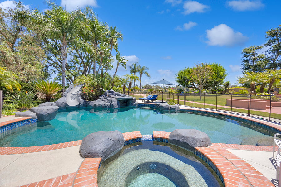 Spend sunny afternoons by the resort-style pool and spa, complete with a rock waterslide, waterfall features, and plenty of space to relax poolside.