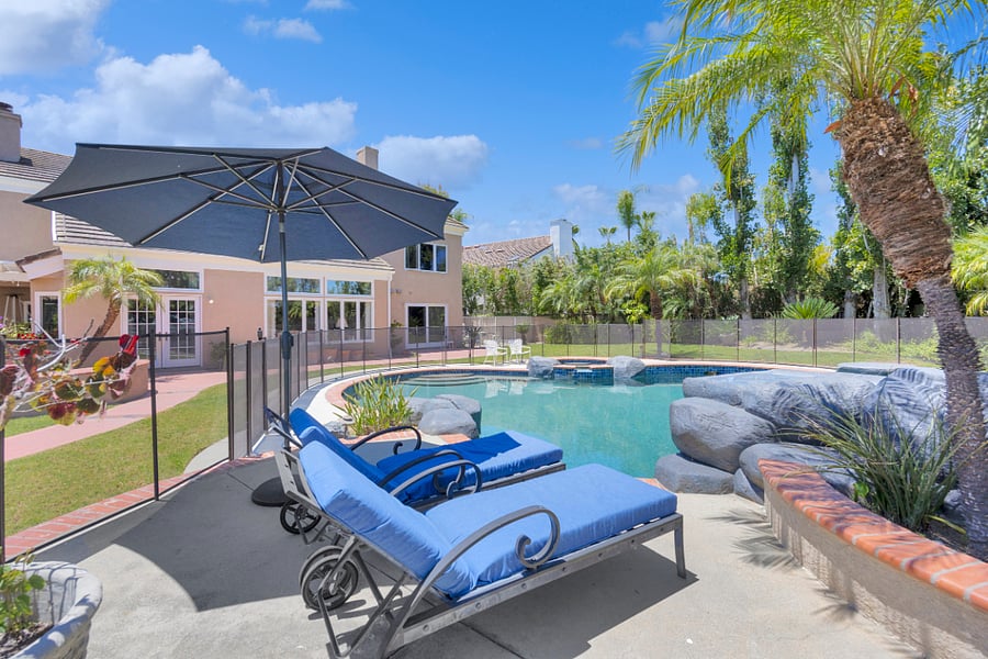 Relax poolside on comfortable loungers beneath the shade umbrella, surrounded by tropical landscaping and your own private resort-style backyard.
