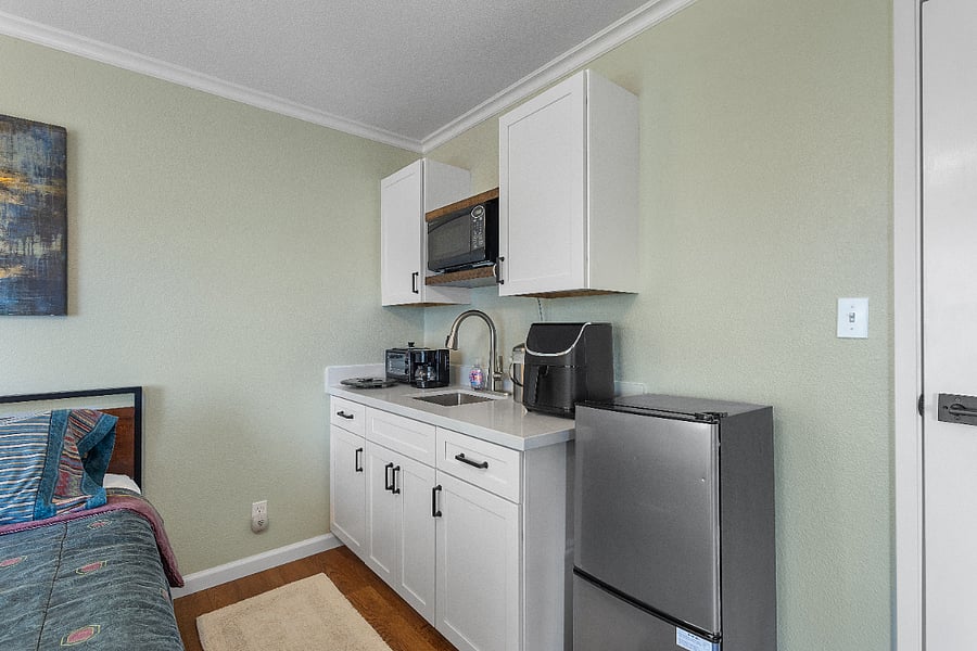 Wet Bar includes a plus-size mini-fridge and freezer, 3-in-1 grill/toaster oven/coffee maker, air fryer, microwave, rice cooker, coffee grinder, Insta Pot, and popcorn maker