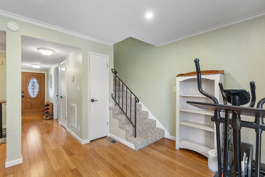 Front door entrance, hallway, and stairs lead to the upstairs bedroom and bathroom