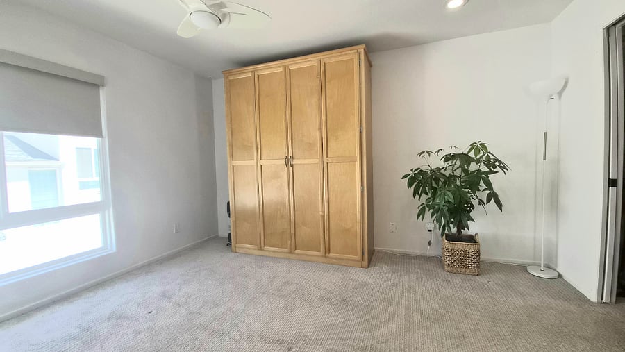 Your bedroom with queen murphy bed, ceiling fan and walk in closet.
