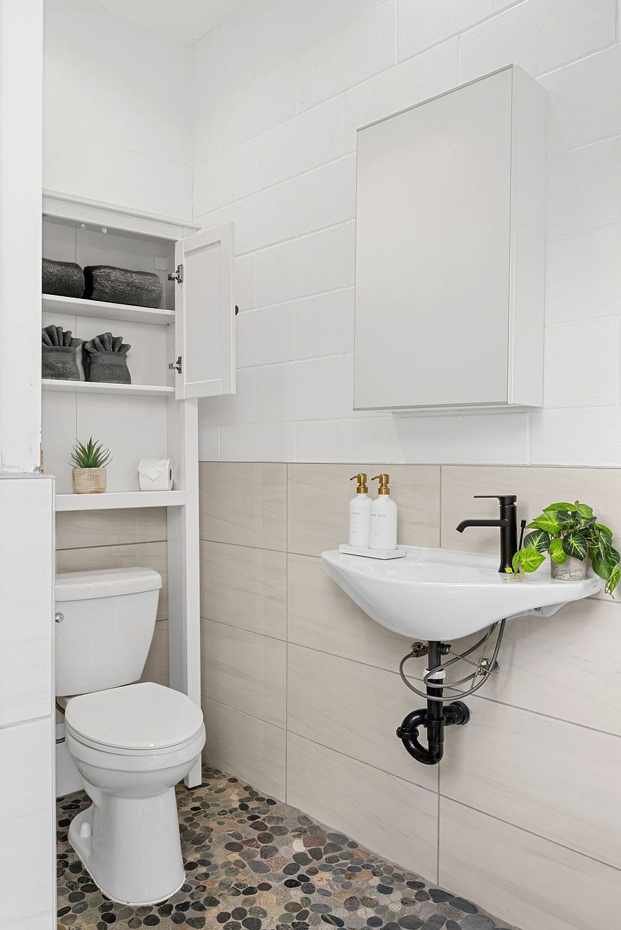 Private casita bathroom with modern vanity and storage.