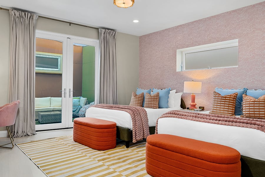 Spacious main bedroom with two full beds and direct outdoor access.