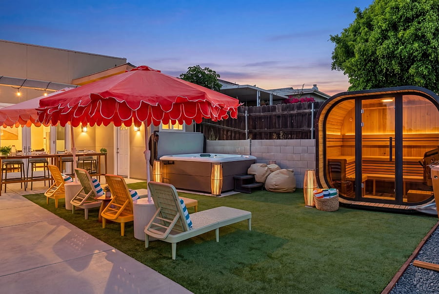 Private outdoor retreat with hot tub, sauna and lounge areas - perfect for unwinding after a long day.