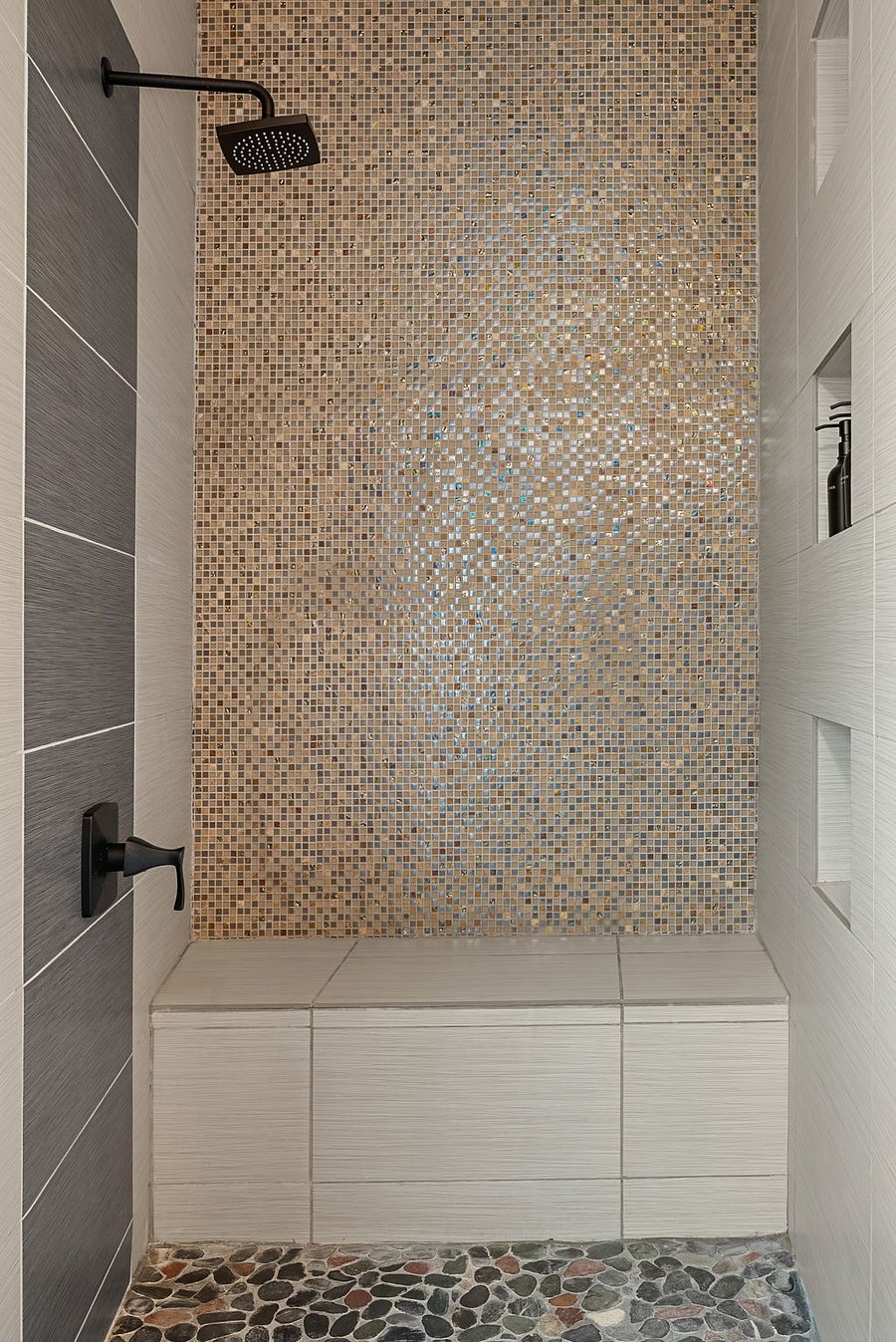 Spacious walk-in shower with modern tile finishes.