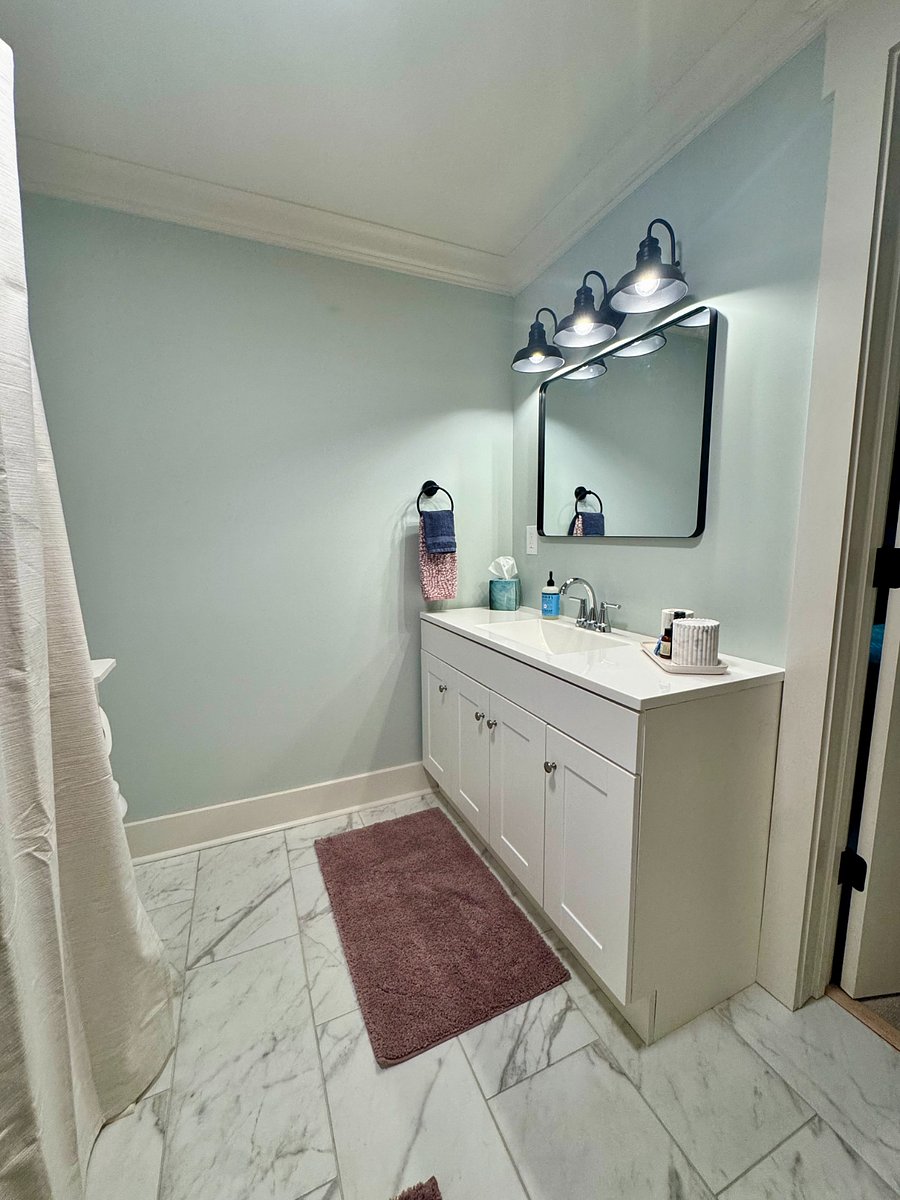 Full sized bath with a large vanity, standard toilet and full size tub/shower combo.